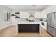 Modern kitchen boasts a marble island, white cabinets, stainless steel appliances and stylish decor at 19550 N Grayhawk Dr # 1144, Scottsdale, AZ 85255