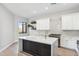 Modern kitchen features a large island, white cabinets, and stainless steel appliances at 19550 N Grayhawk Dr # 1144, Scottsdale, AZ 85255