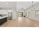 Bright, open concept living room with hardwood floors, modern kitchen, and access to backyard at 19550 N Grayhawk Dr # 1144, Scottsdale, AZ 85255