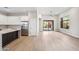 Bright, open-concept living room featuring a modern kitchen with stainless steel appliances and outdoor access at 19550 N Grayhawk Dr # 1144, Scottsdale, AZ 85255