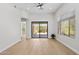 Bright living room featuring hardwood floors, neutral walls, and sliding glass doors to the outdoor space at 19550 N Grayhawk Dr # 1144, Scottsdale, AZ 85255