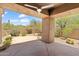 Spacious covered patio with desert landscaping and a ceiling fan at 19550 N Grayhawk Dr # 1144, Scottsdale, AZ 85255