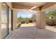 Covered patio featuring decorative concrete, ceiling fan, and serene desert landscaping at 19550 N Grayhawk Dr # 1144, Scottsdale, AZ 85255
