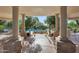 Community pool with a stone archway and decorative pillars at 19550 N Grayhawk Dr # 1144, Scottsdale, AZ 85255