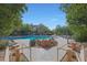 Community pool framed by trees and rocks at 19550 N Grayhawk Dr # 1144, Scottsdale, AZ 85255
