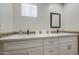 A bathroom boasts a double vanity, stone countertop, and contemporary faucets at 2041 E Des Moines St, Mesa, AZ 85213