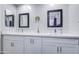Bright bathroom featuring double sinks, vanity with quartz countertops and modern fixtures, plus decorative tile at 2041 E Des Moines St, Mesa, AZ 85213