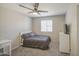Cozy bedroom featuring soft carpet, ceiling fan, a bed, dresser and bright window with natural light at 2041 E Des Moines St, Mesa, AZ 85213