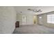 Spacious bedroom featuring carpet, ceiling fan, and multiple doorways leading to other rooms at 2041 E Des Moines St, Mesa, AZ 85213