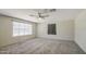 Spacious bedroom featuring soft carpet, ceiling fan, and a bright window with natural light at 2041 E Des Moines St, Mesa, AZ 85213