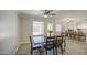 This well-lit dining room has a view into the kitchen featuring wood-look floors and classic details at 2041 E Des Moines St, Mesa, AZ 85213