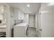 Well-lit laundry room features modern washer/dryer and convenient storage cabinets at 2041 E Des Moines St, Mesa, AZ 85213