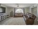 Comfortable living room showcases a vaulted arch window, a sofa, and tile flooring at 2041 E Des Moines St, Mesa, AZ 85213