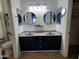 Modern bathroom featuring double sinks, round mirrors, and contemporary fixtures at 2101 S Meridian Rd # 437, Apache Junction, AZ 85120
