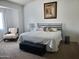 Bright bedroom featuring a large bed with decorative pillows, an accent chair and bench at 2101 S Meridian Rd # 437, Apache Junction, AZ 85120
