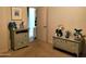 Cozy bedroom with neutral walls, furniture, and an open door leading to another room at 2101 S Meridian Rd # 437, Apache Junction, AZ 85120