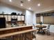 Bright kitchen featuring tiled countertops, stainless steel appliances, breakfast bar, and a cozy dining area with a round table at 2101 S Meridian Rd # 437, Apache Junction, AZ 85120