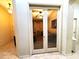 View through double doors into living room with ceiling fan and furniture, warmly lit at 2101 S Meridian Rd # 437, Apache Junction, AZ 85120