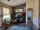 Inviting living room with dark-toned hardwood flooring, a large entertainment center, and comfortable seating arrangements at 2101 S Meridian Rd # 437, Apache Junction, AZ 85120