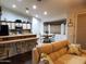 Spacious open-concept living area with views of the kitchen, breakfast bar, dining area, and a comfortable sofa at 2101 S Meridian Rd # 437, Apache Junction, AZ 85120