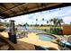 Backyard featuring a spa, lake views, and comfortable patio seating for relaxation and enjoyment of the scenery at 21609 N 61St Ave, Glendale, AZ 85308