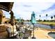 Outdoor patio area overlooking a serene lake with plenty of seating and manicured landscaping at 21609 N 61St Ave, Glendale, AZ 85308