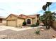 View of home with a two-car garage, drought-resistant landscaping, and tile roof at 21609 N 61St Ave, Glendale, AZ 85308