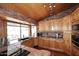 Kitchen featuring granite counters, stainless appliances, and wood cabinetry with brick accent walls at 21609 N 61St Ave, Glendale, AZ 85308