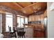 Charming kitchen featuring knotty wood cabinets, brick accents and a granite topped breakfast bar at 21609 N 61St Ave, Glendale, AZ 85308