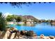 Scenic lake view framed by boulders with homes and a mountain backdrop, perfect for lakeside living and serene views at 21609 N 61St Ave, Glendale, AZ 85308