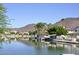 Beautiful lake view featuring waterfront properties, palm trees, a mountain backdrop, and the serene beauty of lakefront living at 21609 N 61St Ave, Glendale, AZ 85308