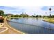 Enjoy the water view with an iron fence overlooking a lake and green hills at 21609 N 61St Ave, Glendale, AZ 85308