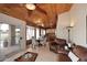 Open living area with brick accent wall, dining space, and a view to outdoor patio at 21609 N 61St Ave, Glendale, AZ 85308