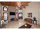 Bright living room with brick fireplace, tile floors, vaulted ceilings, and arched windows at 21609 N 61St Ave, Glendale, AZ 85308