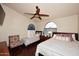 Bright main bedroom with hardwood floors, ceiling fan, and arched windows at 21609 N 61St Ave, Glendale, AZ 85308