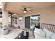 Covered patio with ceiling fan, comfortable seating, views of a nearby lake, and access to the home at 21609 N 61St Ave, Glendale, AZ 85308