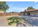 The large backyard has grass, gravel and a covered patio with string lights at 2215 W Highland Ave, Phoenix, AZ 85015