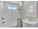 Bathroom featuring a tub with shower, white subway tile, and a stylish vanity with a sink at 2215 W Highland Ave, Phoenix, AZ 85015