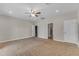 Large carpeted bedroom featuring a ceiling fan and access doors to other rooms at 2215 W Highland Ave, Phoenix, AZ 85015