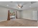 Bedroom with tan walls, ceiling fan, carpet, and sliding door to patio at 2215 W Highland Ave, Phoenix, AZ 85015