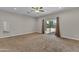 Spacious carpeted bedroom featuring a ceiling fan, patio access, and neutral wall paint at 2215 W Highland Ave, Phoenix, AZ 85015