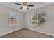 Bedroom features neutral walls, plush carpet, and two windows that fill the space with natural light at 2215 W Highland Ave, Phoenix, AZ 85015