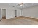 Carpeted bedroom with a ceiling fan, white trim, and multiple access doors at 2215 W Highland Ave, Phoenix, AZ 85015