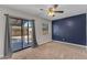 Bedroom with carpeted floor, sliding glass door to backyard, and painted accent wall at 2215 W Highland Ave, Phoenix, AZ 85015