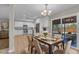 Dining room showcasing ample natural light, modern table setting, and backyard view at 2215 W Highland Ave, Phoenix, AZ 85015