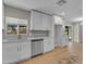 Beautiful kitchen with white cabinets, subway tile backsplash, stainless steel dishwasher, and backyard views at 2215 W Highland Ave, Phoenix, AZ 85015