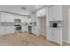 Spacious kitchen featuring white cabinetry, stainless steel appliances, and wood-style flooring at 2215 W Highland Ave, Phoenix, AZ 85015