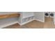 Spacious laundry room featuring wood-look tile floors, a built-in bench, and modern washer and dryer at 2215 W Highland Ave, Phoenix, AZ 85015