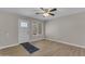 Minimalist living room showcasing hardwood floors, a white door with a window, and a simple yet stylish design at 2215 W Highland Ave, Phoenix, AZ 85015