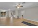 Bright living room with hardwood floors, ceiling fan, and a glimpse into the backyard and other living spaces at 2215 W Highland Ave, Phoenix, AZ 85015